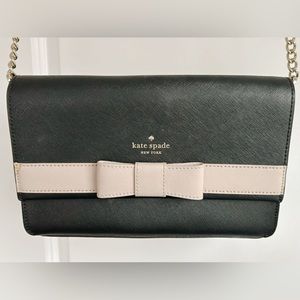 Kate Spade bag with beige bow at front and black and gold strap.